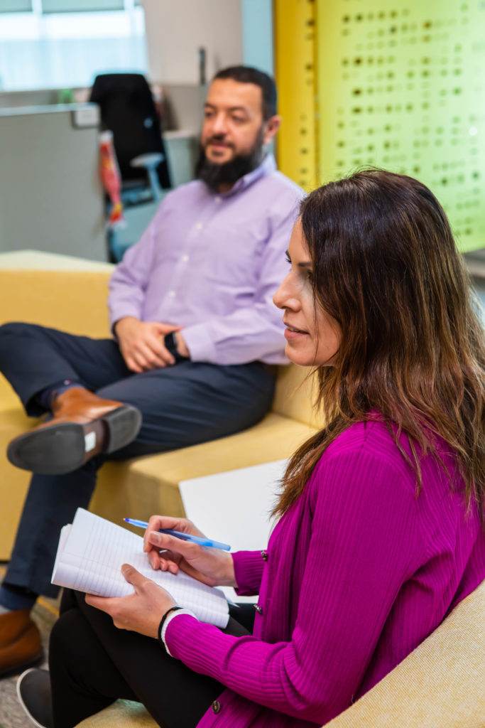 woman and man sitting in a meeting room